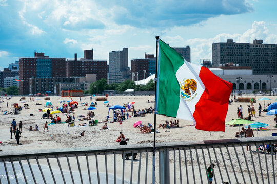 Mexican flag, people relaxing on Brighton Beach, Coney Island, Brooklyn, New York, USA. g2.