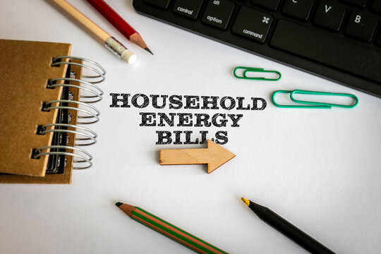 HOUSEHOLD ENERGY BILLS Concept with Wooden Arrow and Office Supplies