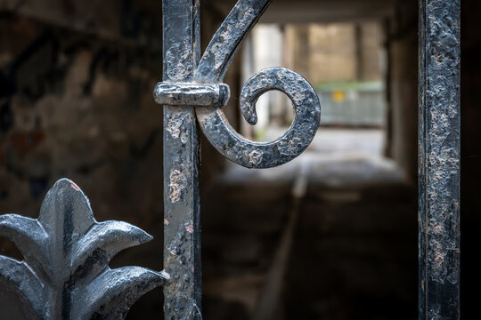 Close-Up of Weathered Ornamental Ironwork on an Old Metal Gate