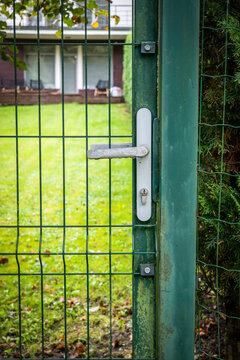 Close-Up of Green Mesh Gate Lock at a Residential Garden