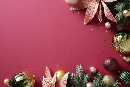 Christmas baubles and decorations on burgundy background with copy space