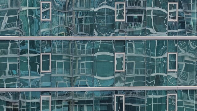 Aerial view of modern glass building facade with reflective windows and geometric architectural patterns in Denver, Colorado, United States.