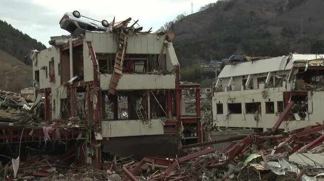 Car Rests On Roof Of Tall Building In Aftermath Of Tsunami In Japan