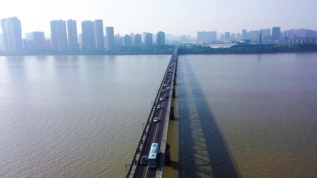 Aerial View of Steel Truss Bridge Over Wide River with City Skyline in Qiantang River, Hangzhou, China