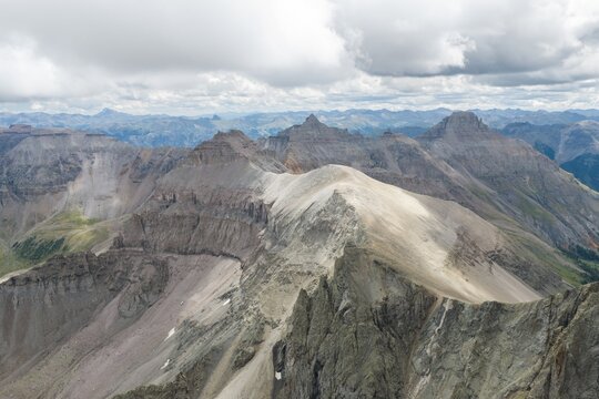 Aerial view of Mount Sneffels and the rugged peaks of the San Juan Mountains in the Rocky Mountains, featuring dramatic rocky ridges and alpine terrain in Ouray County, Colorado, United States.