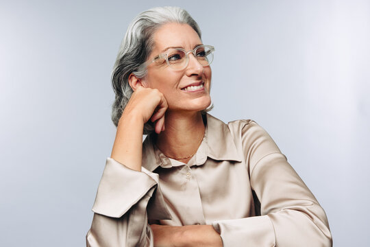 Woman resting chin on hand and smiling