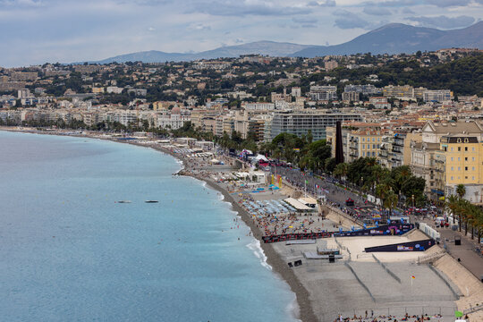 Aerial view of the Promenade des Anglais and the Mediterranean coastline featuring the pebble beach, turquoise water, and urban architecture Nice, Provence-Alpes-Cote d'Azur, France.