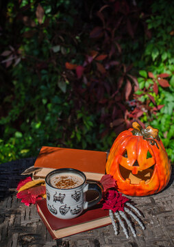 Halloween Still Life with Pumpkin, Skeleton Hand and Ceramic Cat Mug