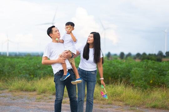 Young family smiles together on  rural path