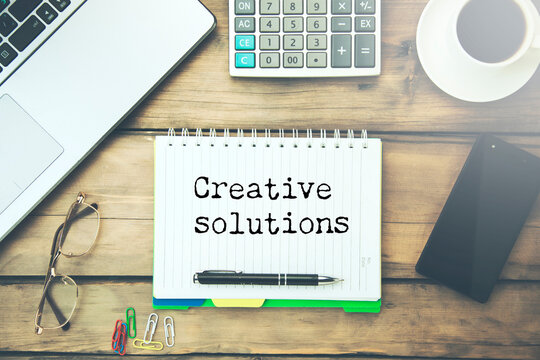 Creative solutions text on paper