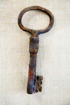 Antique metal key on a light background. The subjects are old technologies. World tourism.