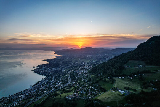 Aerial view of Glion overlooking Lake Geneva at sunset with the town of Montreux nestled along the shoreline in Montreux, Vaud, Switzerland.
