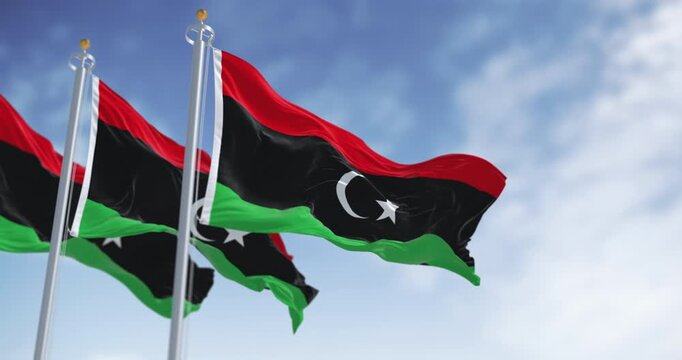 National flags of Libya waving on a clear day.