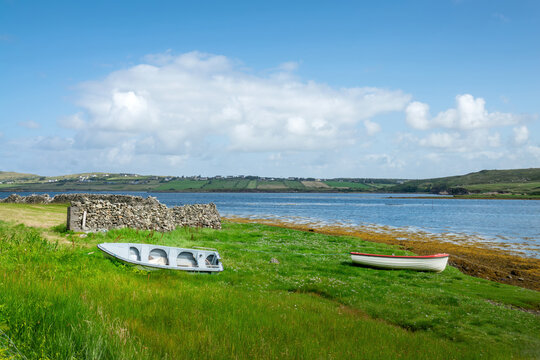 Boats on a grassy shore, coastal landscape in County Donegal near Ardara,Wild Atlantic Way, Ireland