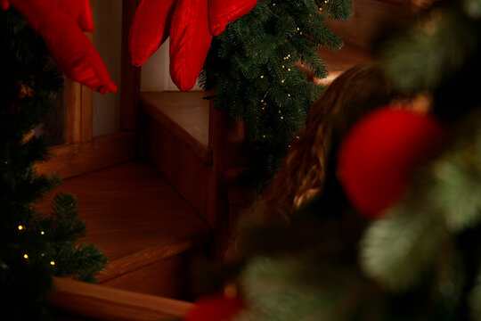 Cozy Christmas interior pine garland and warm lamp illumination at evening dusk time atmosphere