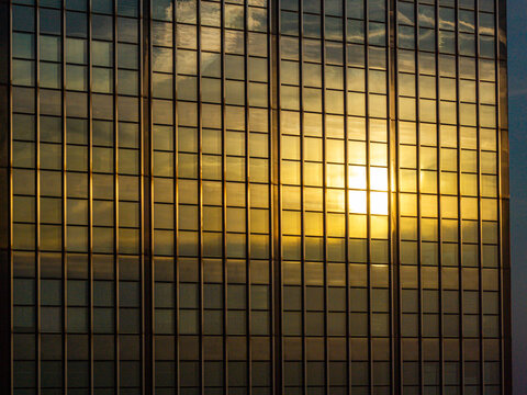Aerial view of the glass facade of the Berlin Treptowers reflecting the golden sunset light in Berlin, Berlin, Germany.
