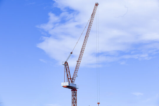 Construction crane blue sky industrial equipment tall structure metal framework outdoor engineering vertical machinery daytime modern technology urban development progress building site calm