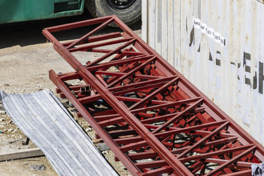 Red metal structure construction steel industrial outdoor equipment framework site horizontal ground Red metal structure lying ground construction site steel framework for industrial use outdoor