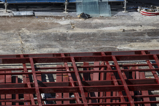 Red steel beam construction site industrial structure horizontal lines outdoor urban development unfinished building daytime metal framework modern architecture
