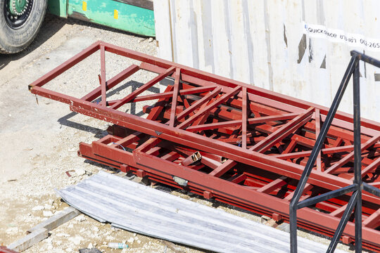 Red steel truss construction material metal frame industrial structure outdoor sunlight building site engineering horizontal equipment urban