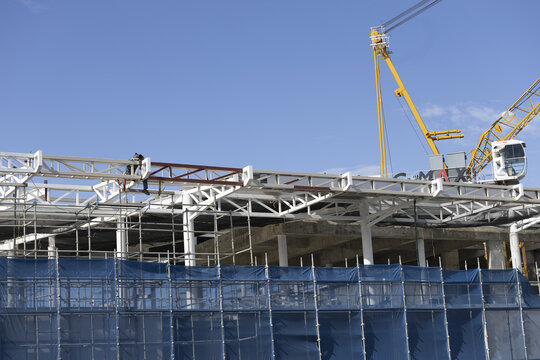 Construction site steel structure blue sky crane scaffolding industrial building architecture outdoor progress safety