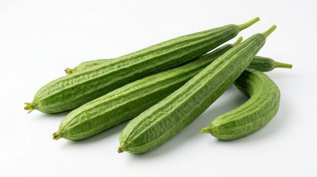 Fresh ridged luffa vegetables clustered on a white background with green vegetable angled luffa sponge gourd organic food raw vegetable healthy food isolated nutrition vegetarian ingredient