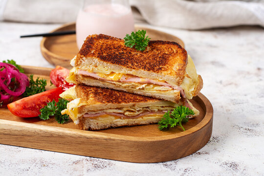 Grilled Ham Cheese and Omelet Sandwich on Wooden Serving Board