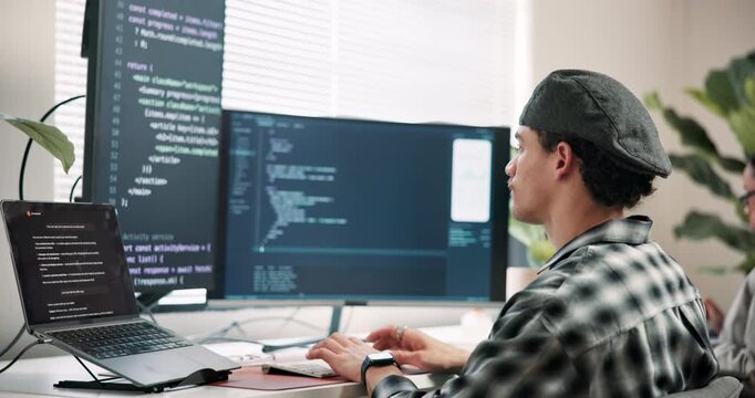 Man, screen and computer in office for coding, programming and update firewall for cybersecurity. Person, coworking and typing in workplace with tech, debugging system and testing for data protection