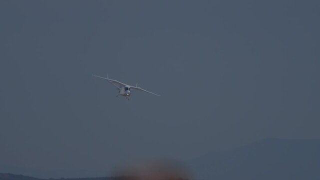 Electric airplane turning its wings in the sky