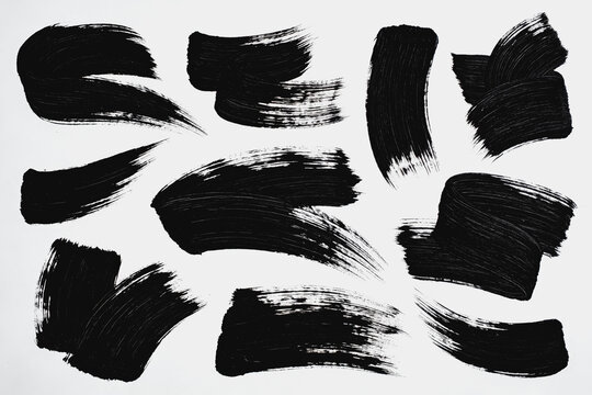 Black Brush Strokes of Different Shapes On White Background