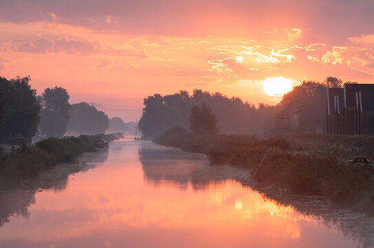 A tranquil, foggy dawn over a canal in the countryside. Meerstad, the Netherlands.
