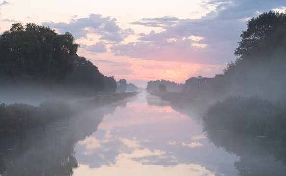 A tranquil, foggy dawn over a canal in the countryside. Meerstad, the Netherlands.