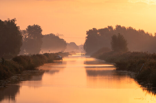 A tranquil, foggy dawn over a canal in the countryside. Meerstad, the Netherlands.