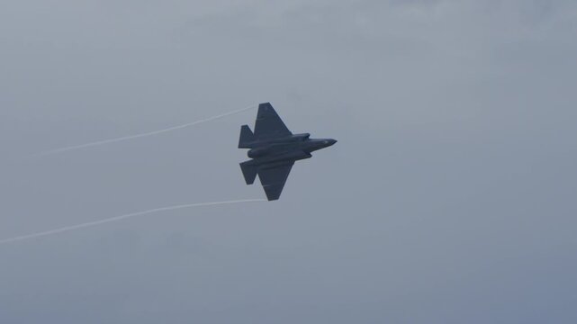 F-35 aircraft doing a large banking turn during an air show