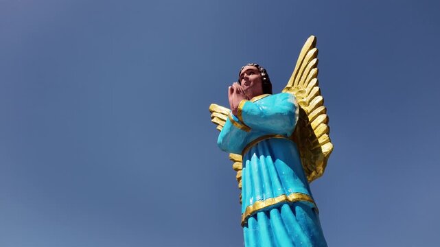 Praying angel statue in blue robe at Simala Shrine, Cebu