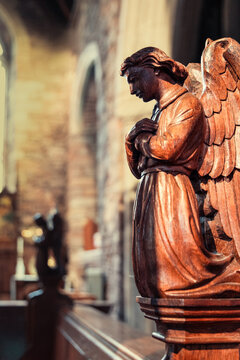 Carved Wooden Angel On The End Of A Pew In Cockington Court Parish Church In Cockington, Devon, England