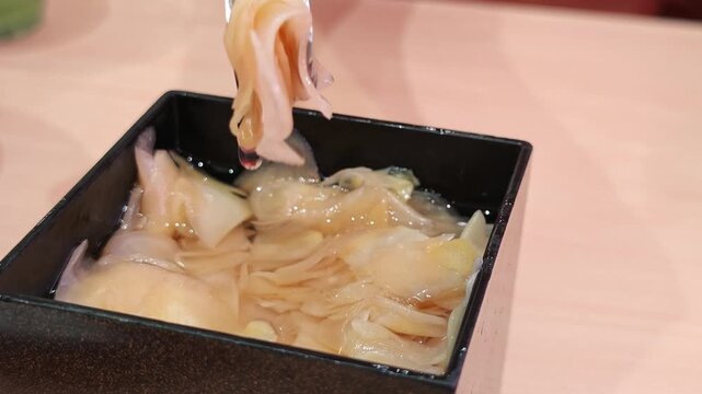 Pickled ginger in a bowl, a popular sushi accompaniment.