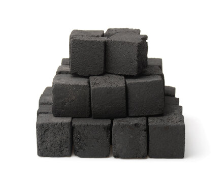 Pile of black pressed charcoal cubes
