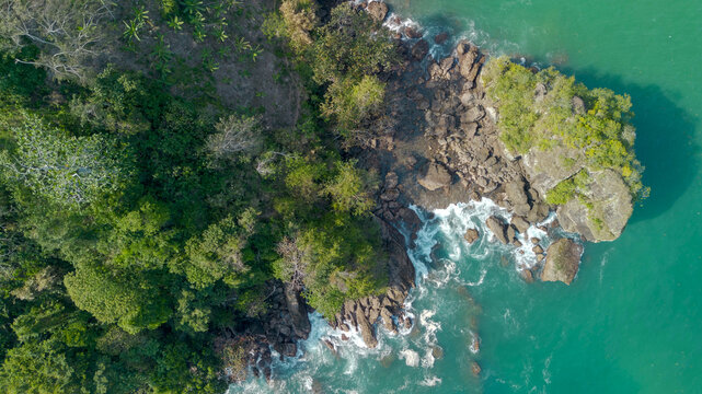 Aerial view of Wedi Awu beach bay with turquoise ocean and lush green hills in Malang East Java