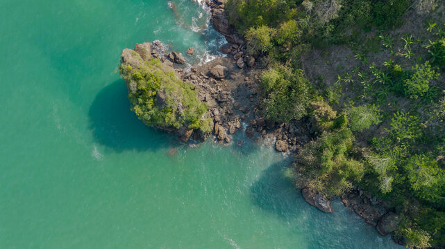 Aerial view of Wedi Awu beach bay with turquoise ocean and lush green hills in Malang East Java