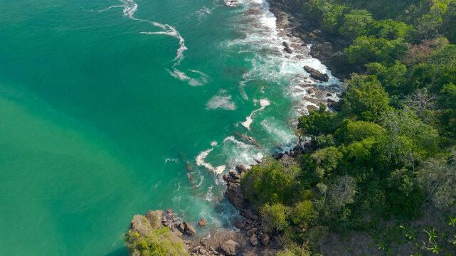Aerial view of Wedi Awu beach bay with turquoise ocean and lush green hills in Malang East Java