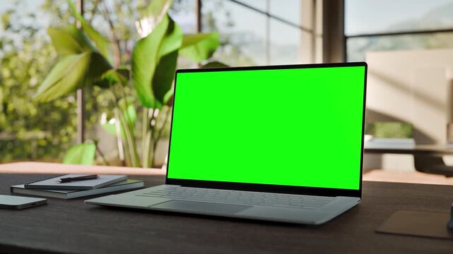 Laptop PC  Blank Green Screen on Desk in Bright Bophilic Office