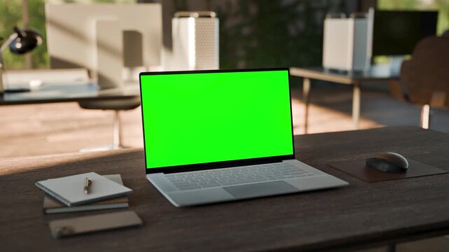 Laptop PC  Blank Green Screen on Desk in Bright Bophilic Office