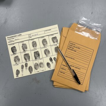 Fingerprint Card and Evidence Envelopes with Pen Crime Scene Investigation and Forensics Concept