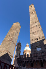 The Two Towers, adjacent to the Strada Maggiore in Bologna, Italy.In the background the Santi Bartolomeo e Gaetano. It is a Renaissance style, Roman Catholic church © Lunghammer