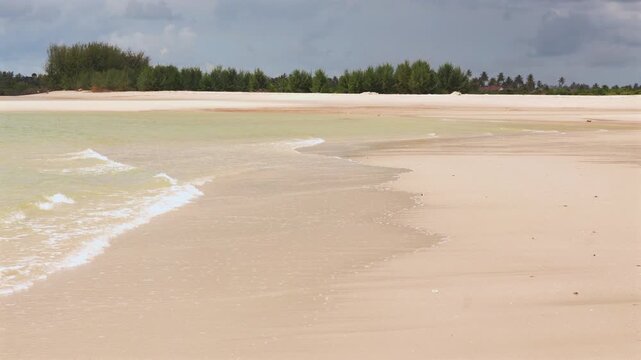 igamboni beach in Dar es Salaam Tanzania featuring golden sand ocean waves sunlight and exotic tropical coastal landscape