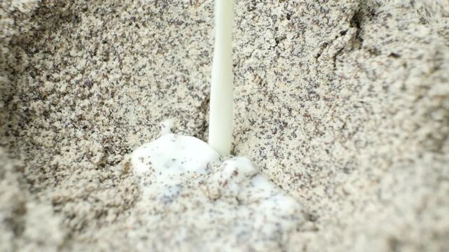 Adding milk to ground poppy seeds mixture for baking slow motion.