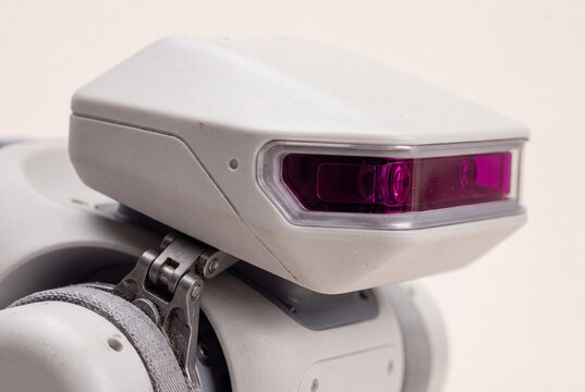 Close-up of quadruped robot head with magenta sensor strip