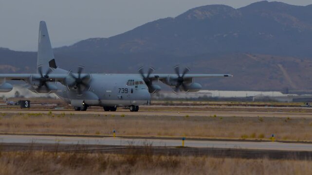 Large propeller plane driving on a runway during an airshow