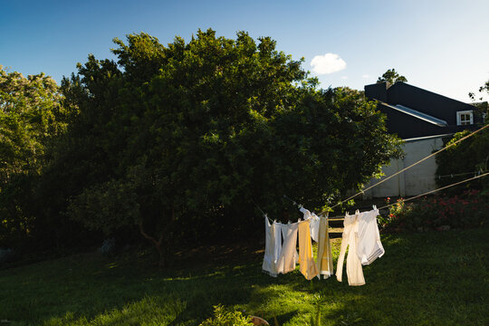 clothes on clothes line  blowing in wind early morning 